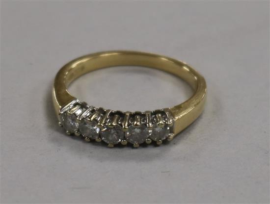 An 18ct gold and five stone diamond half hoop ring, size N.